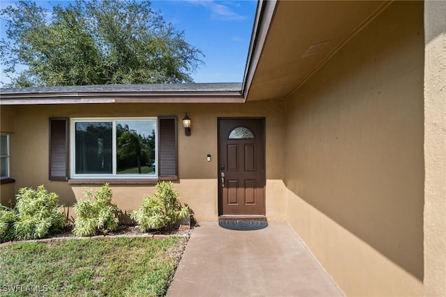 doorway to property with stucco siding