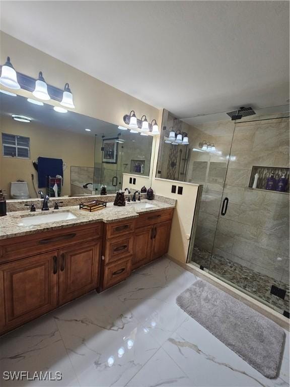 bathroom with a shower with door and vanity