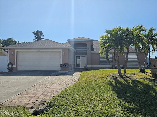 view of front facade with a garage and a front lawn