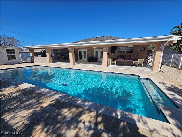 view of pool featuring french doors, outdoor lounge area, and a patio