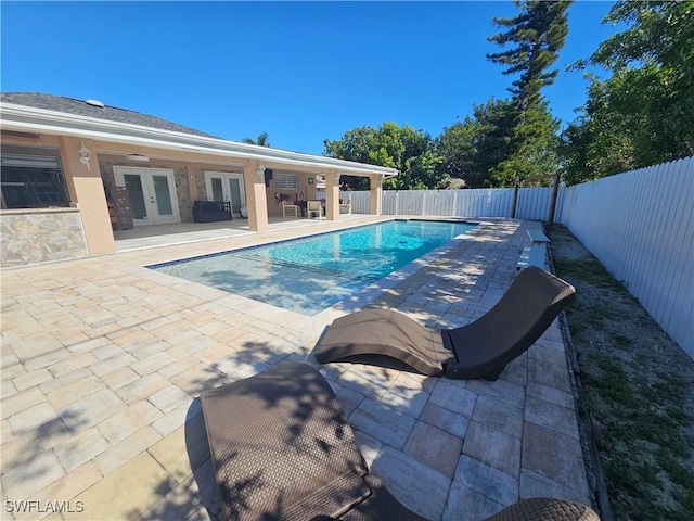 view of pool featuring a patio and french doors