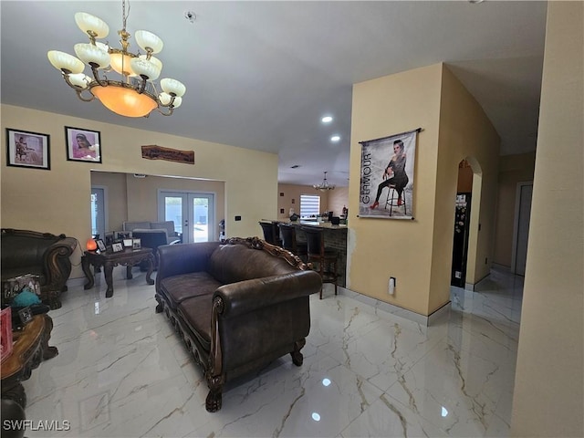 living room with a notable chandelier and french doors