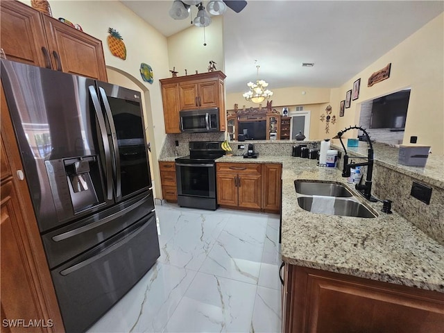 kitchen with sink, appliances with stainless steel finishes, tasteful backsplash, light stone countertops, and kitchen peninsula