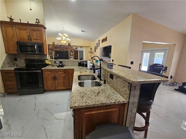 kitchen featuring lofted ceiling, sink, a kitchen breakfast bar, light stone counters, and black range with electric stovetop