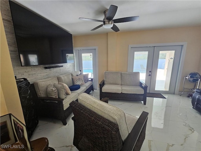 living room with plenty of natural light, french doors, and ceiling fan