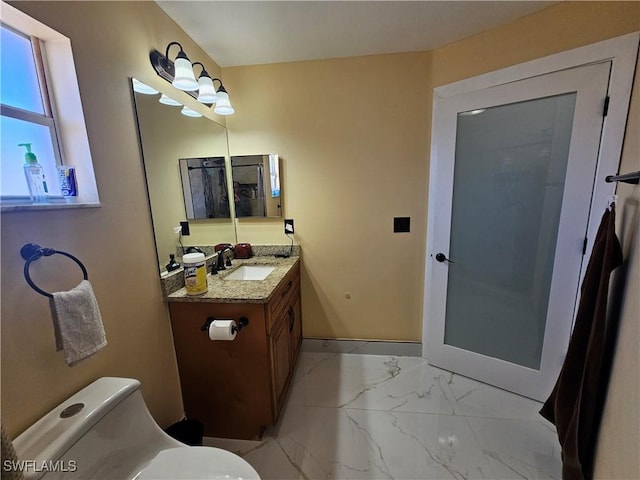 bathroom featuring vanity and toilet