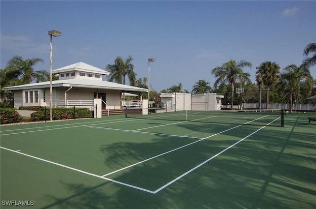 view of tennis court featuring fence