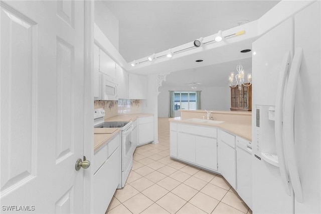 kitchen featuring sink, white cabinetry, light tile patterned floors, pendant lighting, and white appliances