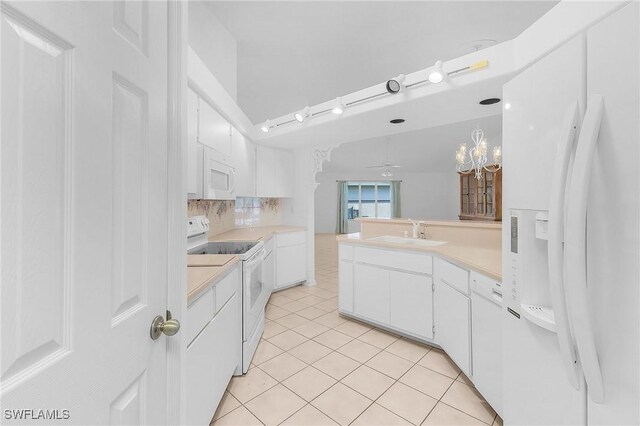 kitchen with light countertops, white appliances, light tile patterned flooring, and a sink