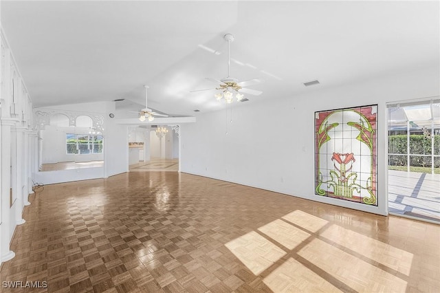 unfurnished living room featuring vaulted ceiling and parquet flooring