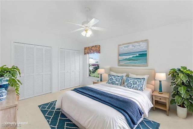 bedroom featuring a ceiling fan and multiple closets