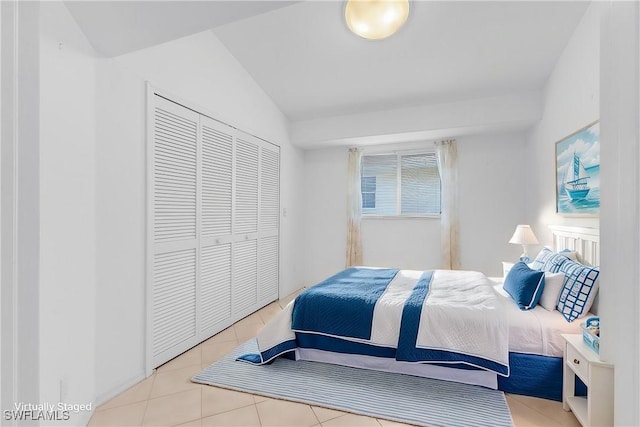 tiled bedroom featuring a closet