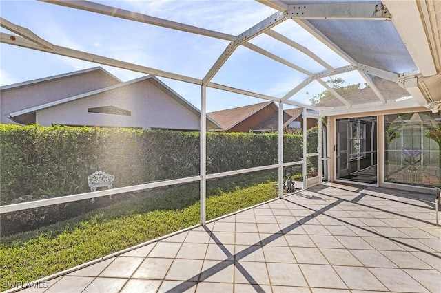 unfurnished sunroom featuring lofted ceiling