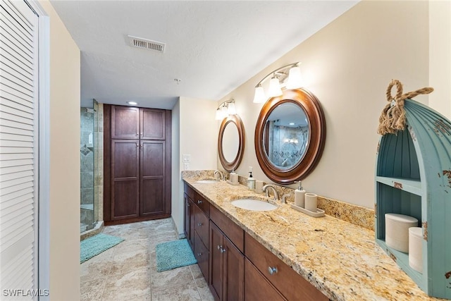 bathroom featuring vanity, a textured ceiling, and walk in shower