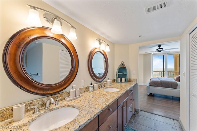 bathroom featuring ceiling fan, vanity, and tile patterned flooring