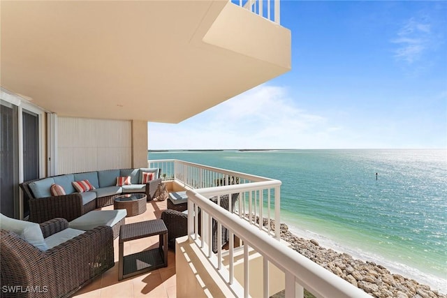 balcony with a water view, an outdoor living space, and a view of the beach