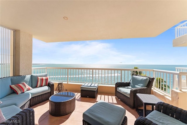 balcony with a water view and an outdoor living space