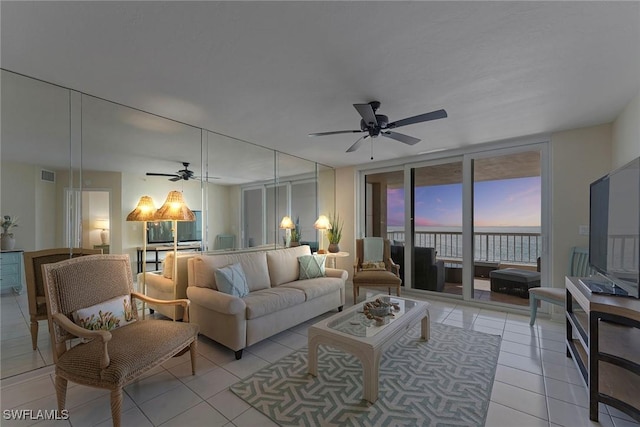 living room with ceiling fan and light tile patterned flooring