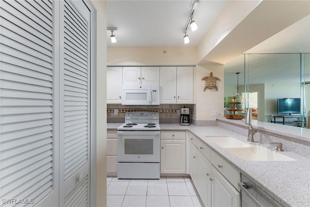 kitchen featuring sink, white cabinetry, light tile patterned floors, white appliances, and decorative backsplash