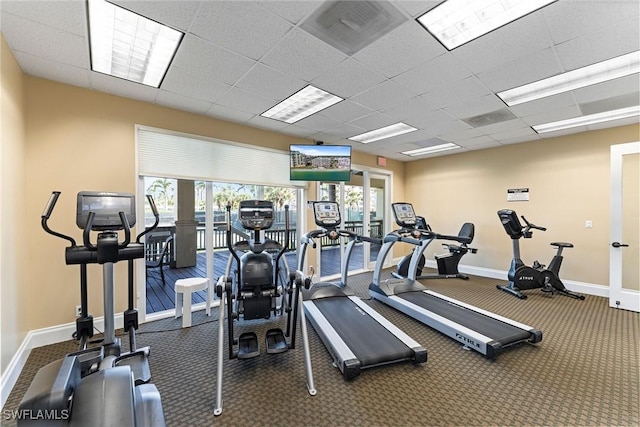 gym with a paneled ceiling