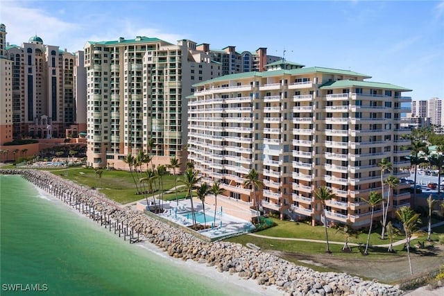 view of property with a water view and a view of the beach