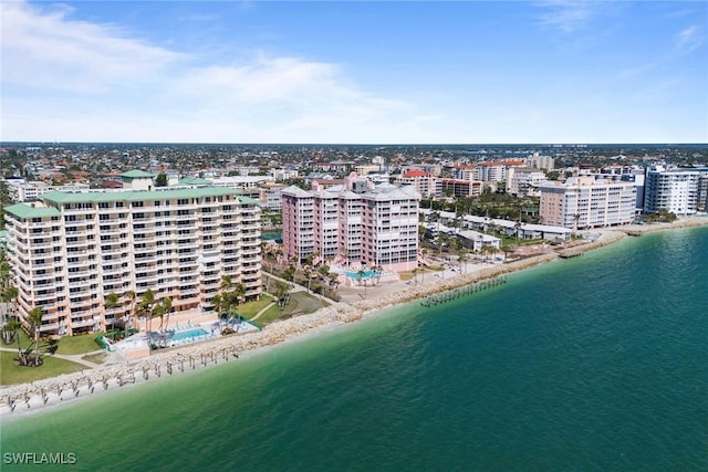 aerial view with a water view and a beach view