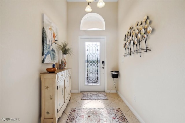 entryway featuring light tile patterned floors and baseboards