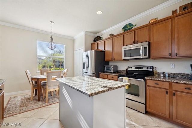 kitchen with light tile patterned floors, a kitchen island, brown cabinets, and stainless steel appliances