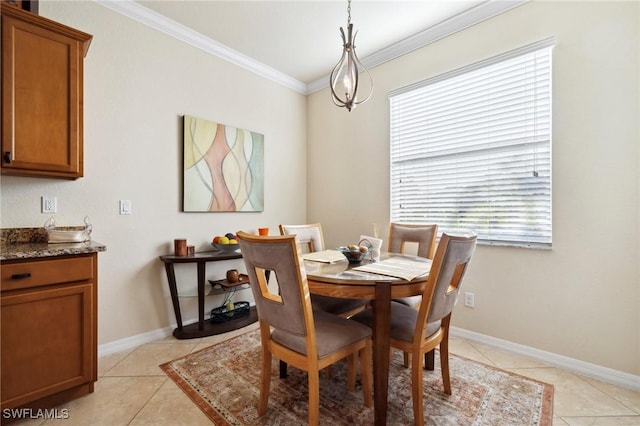 dining room featuring light tile patterned flooring, crown molding, and baseboards