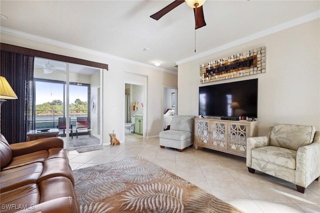 living room featuring crown molding, light tile patterned floors, baseboards, and ceiling fan