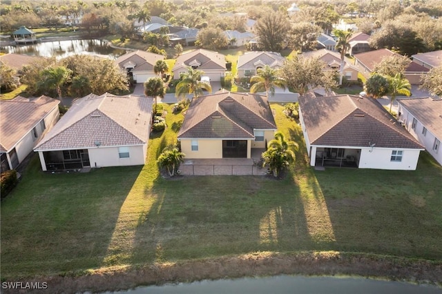 drone / aerial view featuring a residential view and a water view