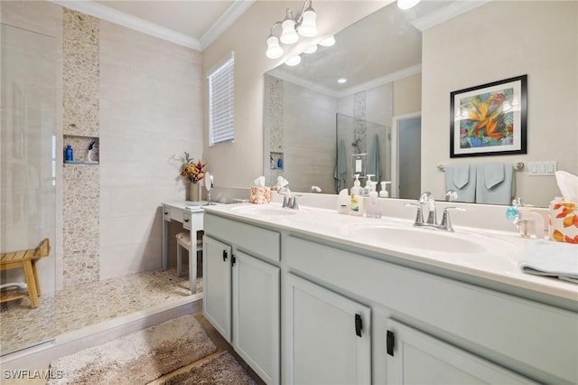 full bathroom with double vanity, a walk in shower, crown molding, and a sink