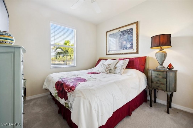 bedroom with baseboards, carpet floors, and a ceiling fan