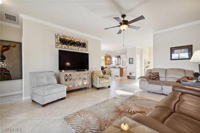 living room featuring visible vents, light tile patterned flooring, crown molding, baseboards, and ceiling fan