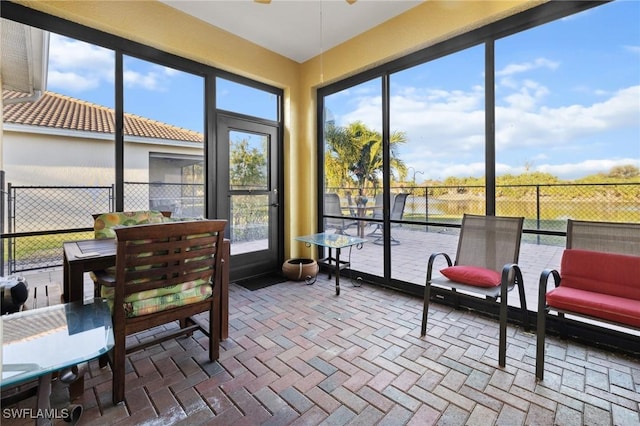 sunroom with a ceiling fan and a healthy amount of sunlight