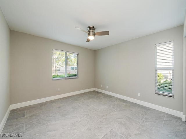 empty room featuring a wealth of natural light and ceiling fan