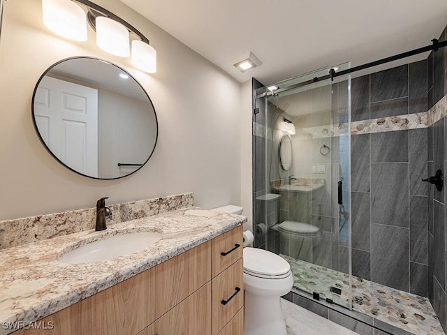 bathroom with vanity, toilet, and walk in shower