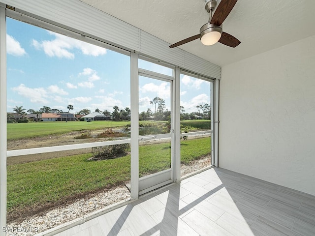 sunroom / solarium featuring ceiling fan