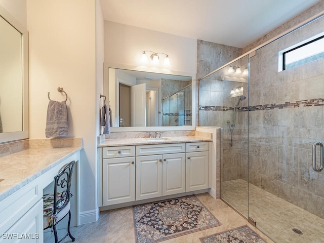 bathroom featuring vanity and a shower with door