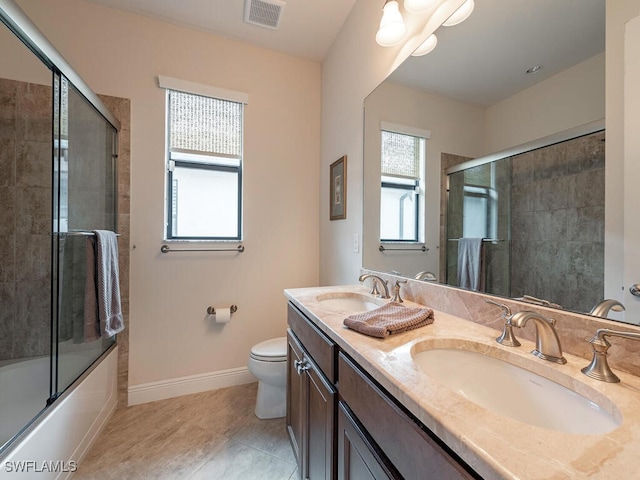 full bathroom featuring vanity, tile patterned floors, enclosed tub / shower combo, and toilet