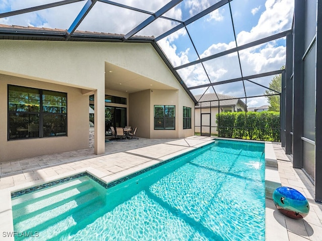 view of pool with a patio and glass enclosure