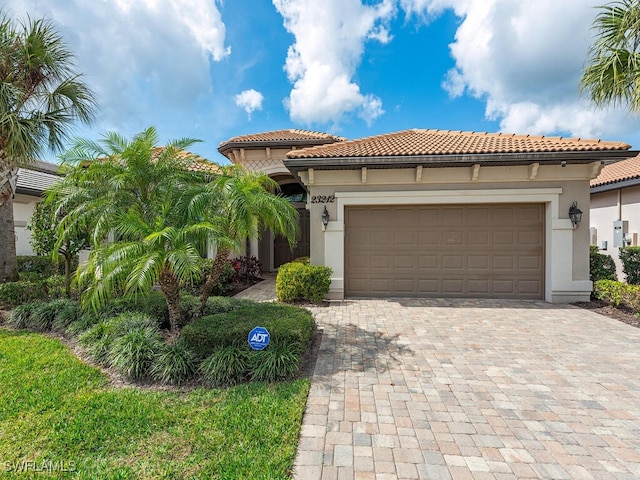 mediterranean / spanish-style home with a garage