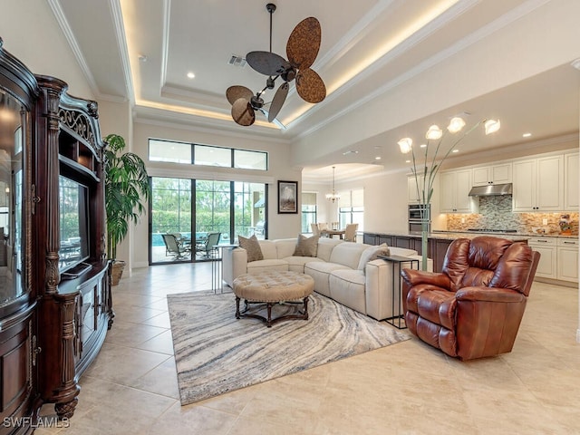 tiled living room featuring crown molding, a raised ceiling, and ceiling fan