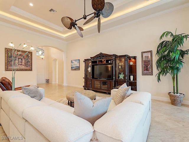 living room with crown molding, a raised ceiling, and ceiling fan