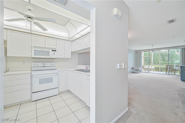 kitchen with white appliances, a ceiling fan, visible vents, a sink, and light carpet