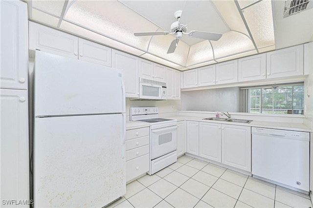 kitchen with white appliances, a ceiling fan, a sink, light countertops, and white cabinetry