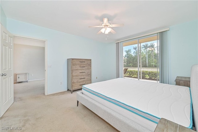 bedroom featuring light carpet and a ceiling fan