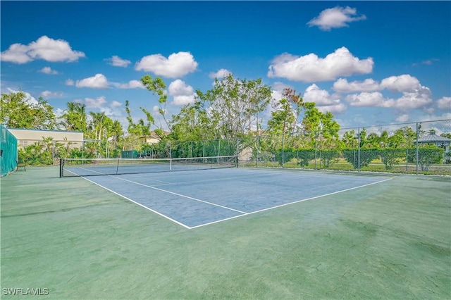 view of tennis court featuring fence