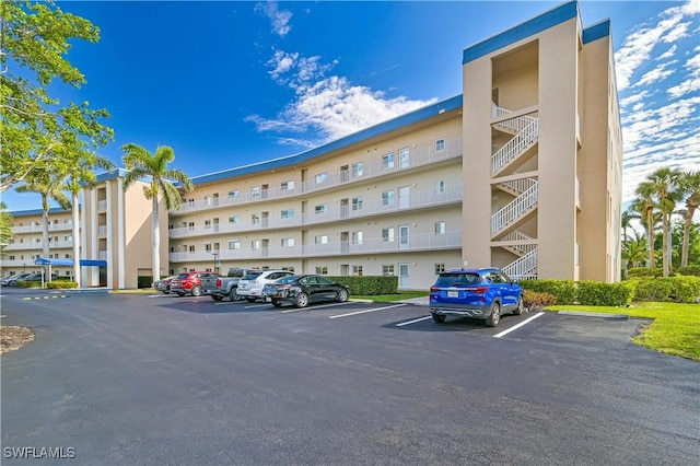 view of building exterior with uncovered parking