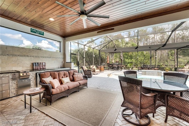 view of patio / terrace featuring area for grilling, an outdoor living space, a lanai, and ceiling fan